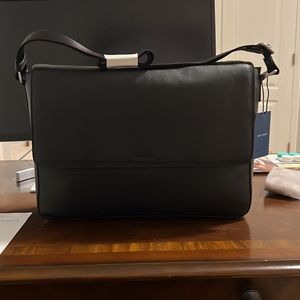 Brand new. Black Cole Haan messenger bag with crossbody strap
